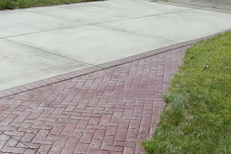 This driveway's border uses the Herringbone Brick stamp and the Brick Red color.